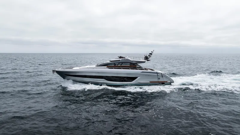 Slide: The Image of 2024 Riva 66' Ribelle yacht cruising on open sea under cloudy skies. - 8