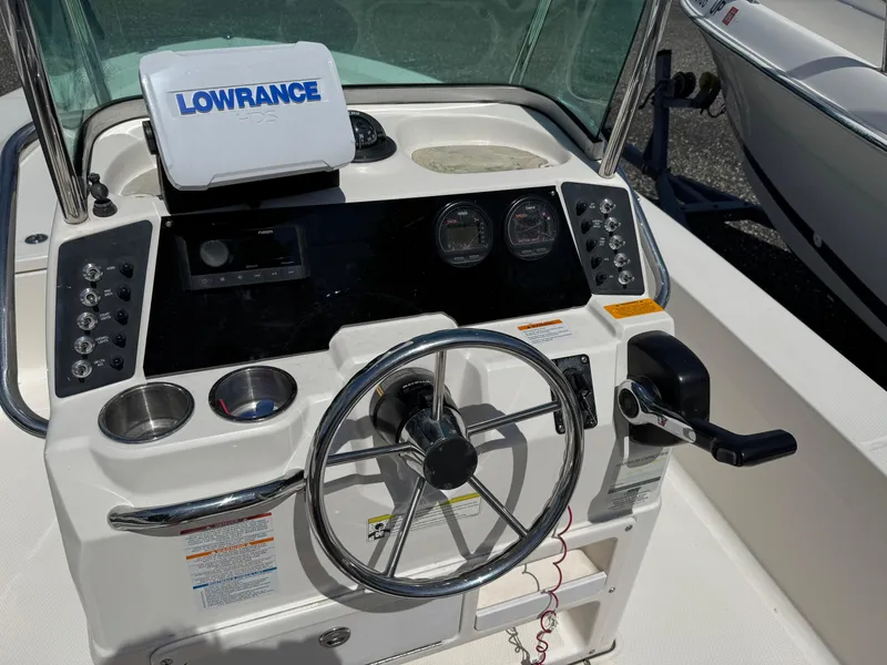 Slide: The Image of 2014 Robalo 206 Cayman boat console with steering wheel and Lowrance navigation system. - 10