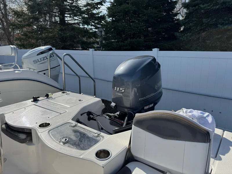 Slide: The Image of 2014 Robalo 206 Cayman boat with Suzuki 115 outboard motor, parked outdoors. - 12