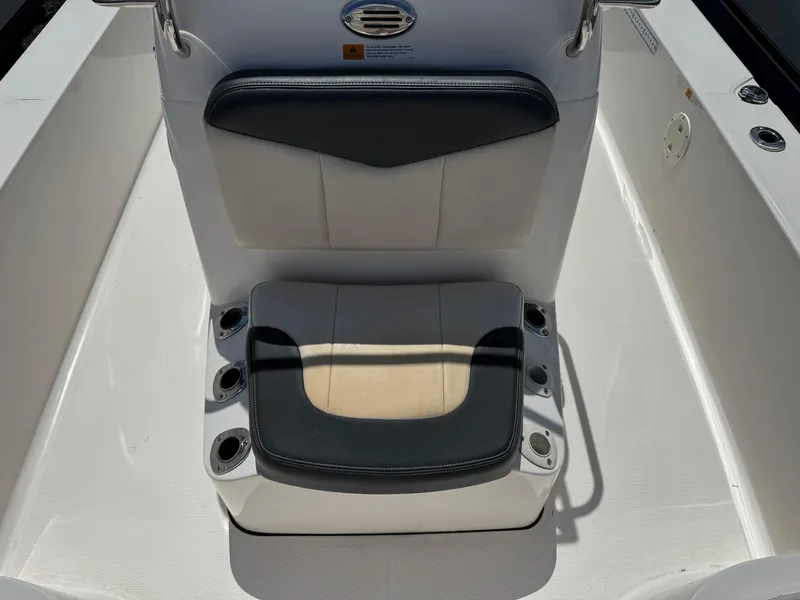 Slide: The Image of 2014 Robalo 206 Cayman boat seat with cup holders, white and black design. - 4