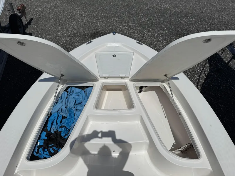 Slide: The Image of 2014 Robalo 206 Cayman boat storage compartments open, showing interior space. - 5