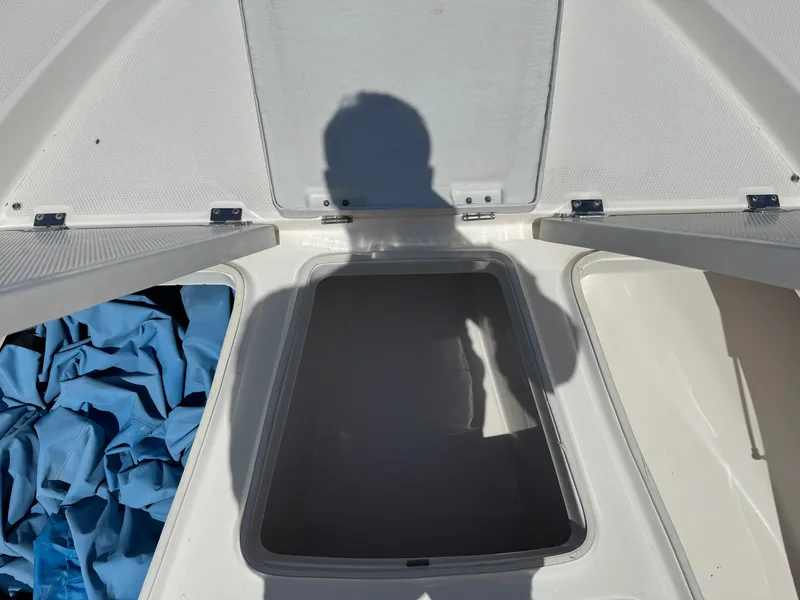 Slide: The Image of 2014 Robalo 206 Cayman boat storage compartment with open hatch and shadow. - 6