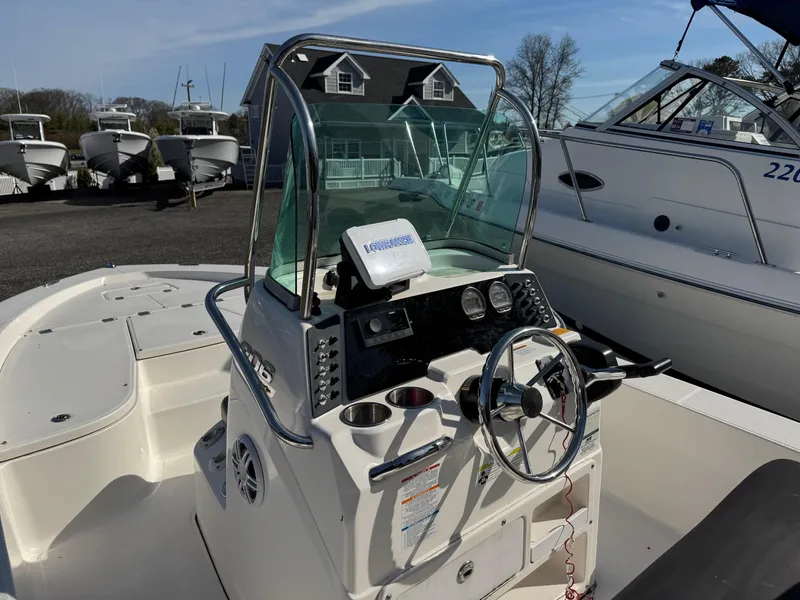 Slide: The Image of 2014 Robalo 206 Cayman boat cockpit with steering wheel and control panel. - 9