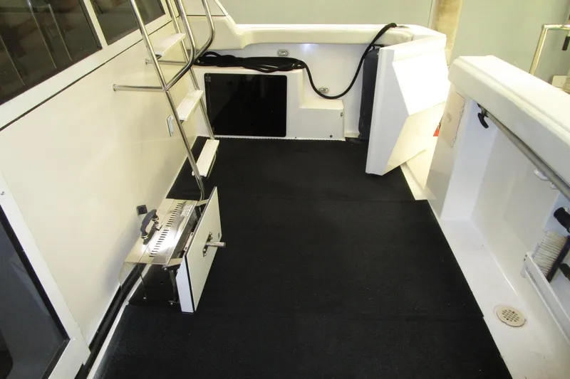 Slide: The Image of 1999 Bayliner 4788 Pilot House Motoryacht deck with ladder and storage compartments. - 10
