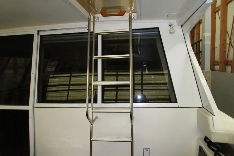 Slide: The Image of 1999 Bayliner 4788 Pilot House Motoryacht interior with ladder and window view. - 12