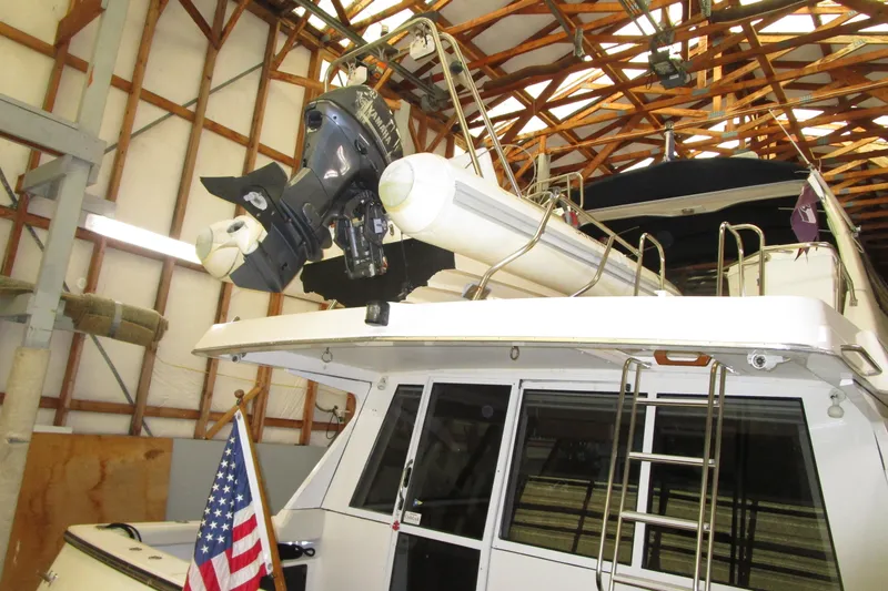 Slide: The Image of 1999 Bayliner 4788 Pilot House Motoryacht in storage with American flag. - 13