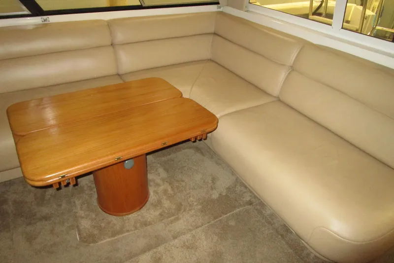 Slide: The Image of Luxurious beige seating and wooden table inside 1999 Bayliner 4788 Pilot House Motoryacht. - 17