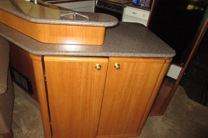 Slide: The Image of 1999 Bayliner 4788 Pilot House Motoryacht interior with wooden cabinetry and countertop. - 20