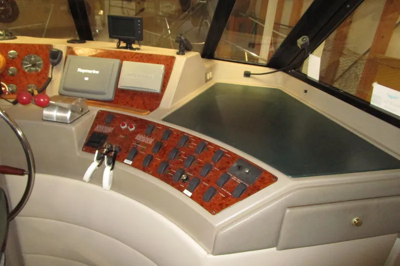 Slide: The Image of 1999 Bayliner 4788 Pilot House Motoryacht helm with navigation controls and instruments. - 29