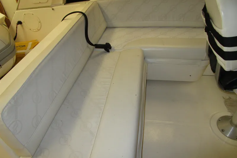 Slide: The Image of 1999 Bayliner 4788 Pilot House Motoryacht interior seating area with white upholstery. - 33