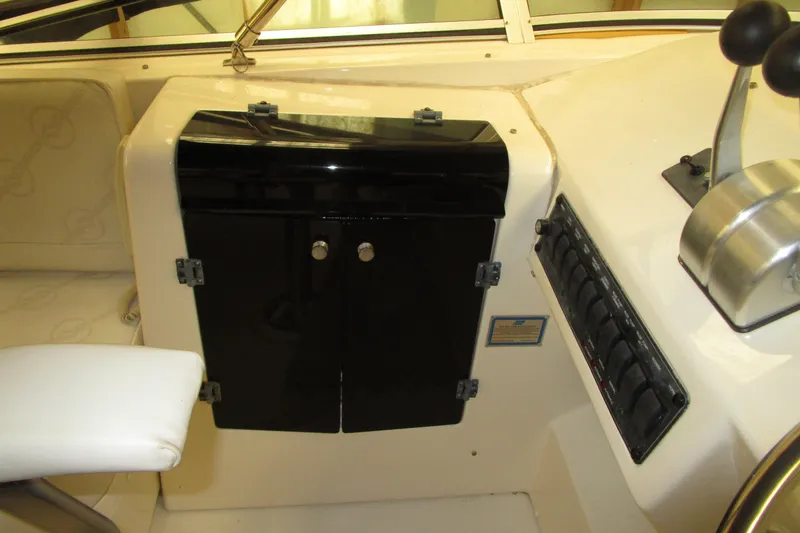 Slide: The Image of 1999 Bayliner 4788 Pilot House Motoryacht helm with control panel and seating. - 34