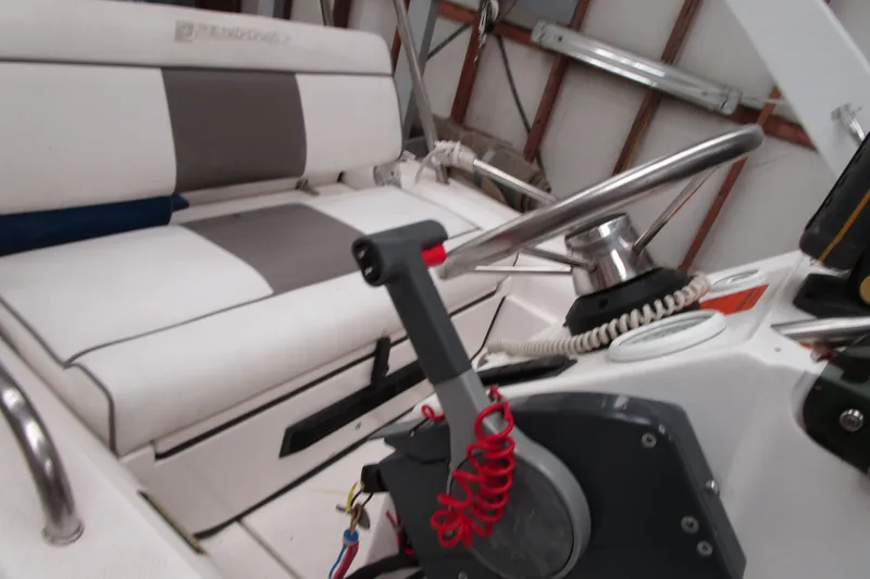 Slide: The Image of 1999 Bayliner 4788 Pilot House Motoryacht helm with steering wheel and throttle controls. - 38