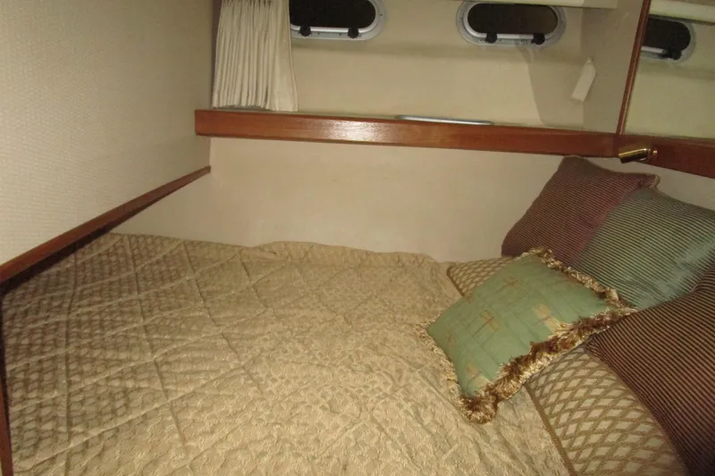 Slide: The Image of Cozy cabin interior of 1999 Bayliner 4788 Pilot House Motoryacht with plush bedding. - 42