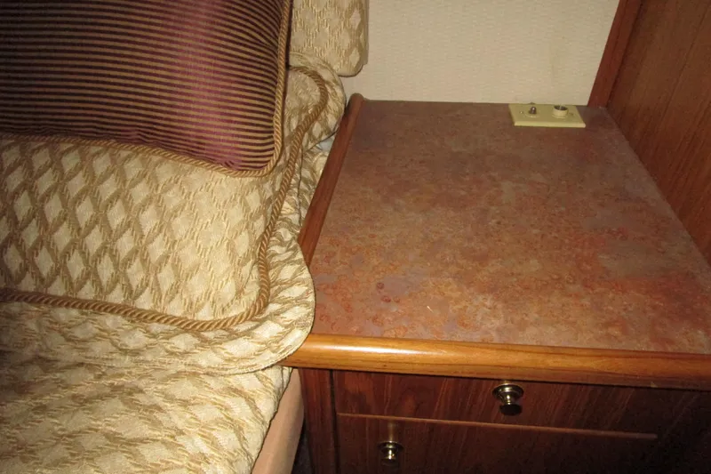 Slide: The Image of 1999 Bayliner 4788 Pilot House Motoryacht interior with bed and wooden nightstand. - 43