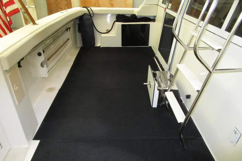 Slide: The Image of 1999 Bayliner 4788 Pilot House Motoryacht interior with black flooring and stainless steel ladder. - 5