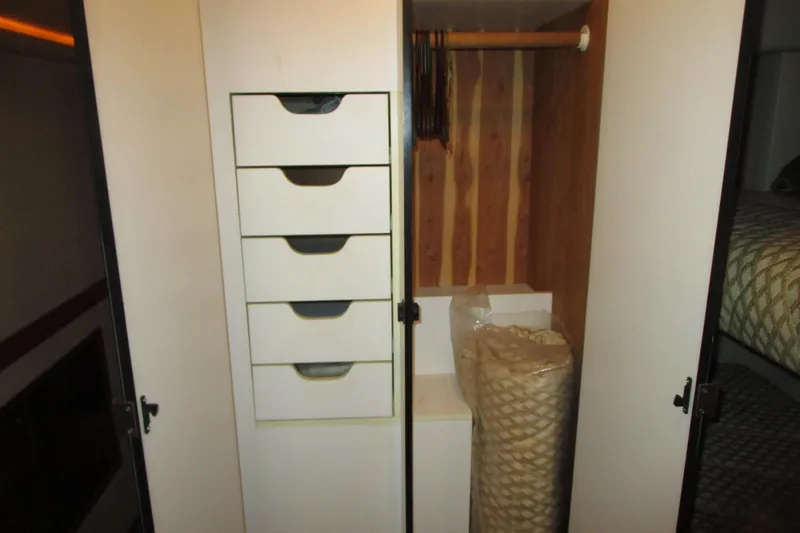 Slide: The Image of Interior storage of 1999 Bayliner 4788 Pilot House Motoryacht with drawers and hanging space. - 56