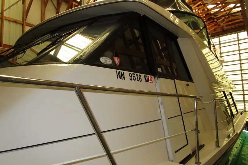 Slide: The Image of 1999 Bayliner 4788 Pilot House Motoryacht in storage, side view with registration number. - 67