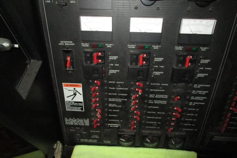 Slide: The Image of Electrical panel of a 1999 Bayliner 4788 Pilot House Motoryacht with various switches and meters. - 71