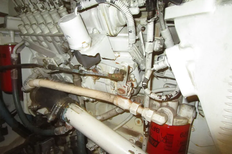 Slide: The Image of Engine components of a 1999 Bayliner 4788 Pilot House Motoryacht, featuring hoses and filters. - 75