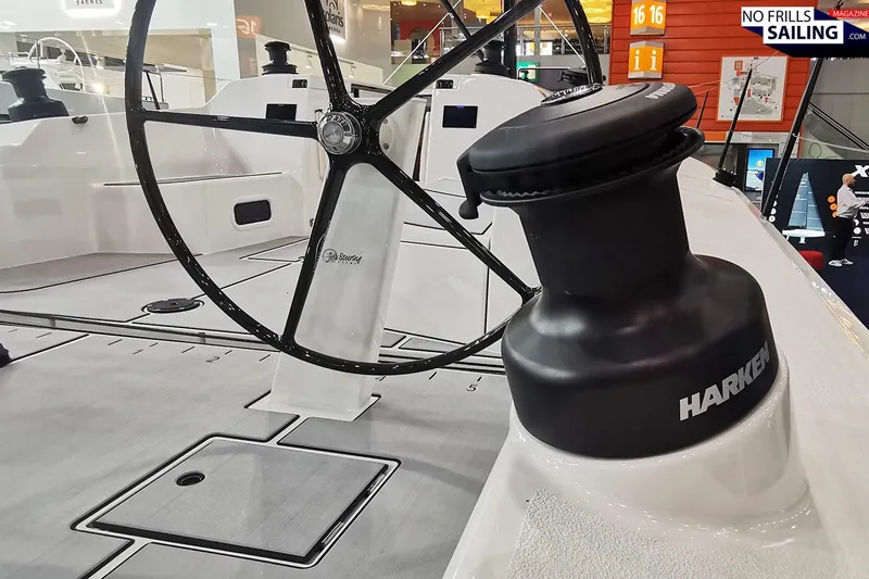 Slide: The Image of 2025 X-Yachts XR 41 sailboat deck with Harken winch and steering wheel. - 12
