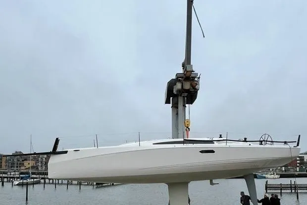 Slide: The Image of 2025 X-Yachts XR 41 sailboat being lifted at a marina. - 3
