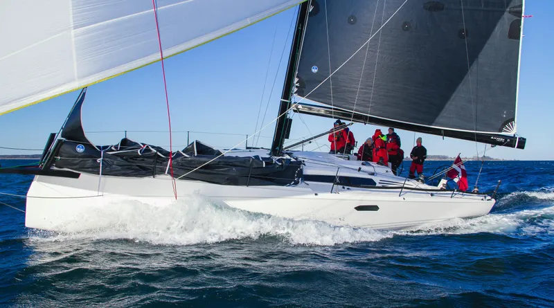 Slide: The Image of 2025 X-Yachts XR 41 sailboat being lifted at a marina. - 13