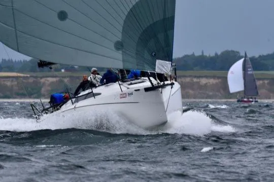 Slide: The Image of 2025 X-Yachts XR 41 sailing yacht with large white sail on open water. - 5