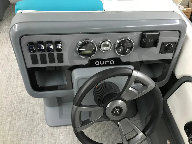 Slide: The Image of 2025 Avalon AURA boat interior with white and teal seating, gray flooring. - 15