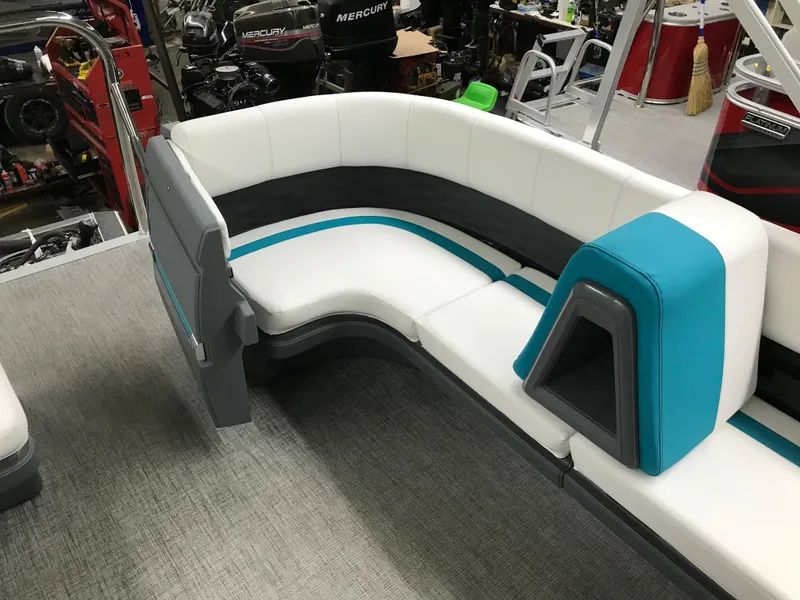 Slide: The Image of Luxurious 2025 Avalon AURA boat interior with white and teal seating in a spacious layout. - 19