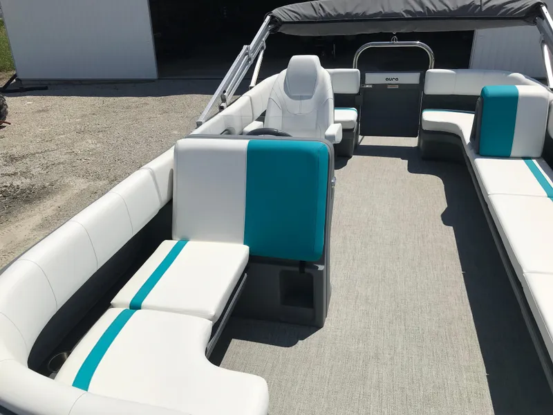 Slide: The Image of 2025 Avalon AURA boat interior with white and teal seating arrangement. - 30