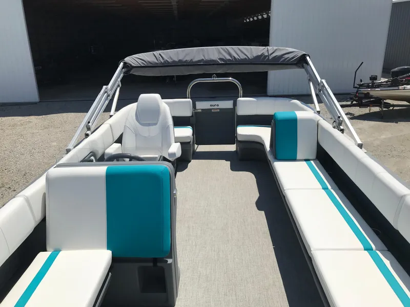 Slide: The Image of 2025 Avalon AURA boat interior with white and teal seating, spacious layout. - 32