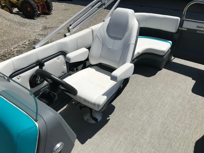 Slide: The Image of 2025 Avalon AURA pontoon boat interior with white and teal seating. - 33
