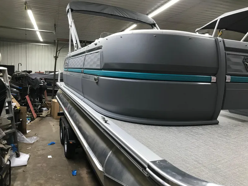 Slide: The Image of 2025 Avalon AURA pontoon boat in a garage, featuring sleek design and modern build. - 5