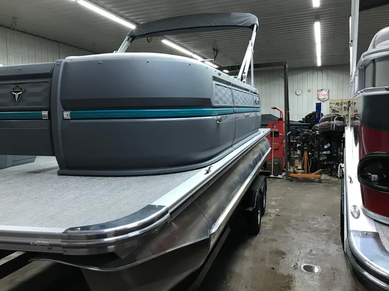Slide: The Image of 2025 Avalon AURA pontoon boat in a garage, showcasing sleek design and modern features. - 6