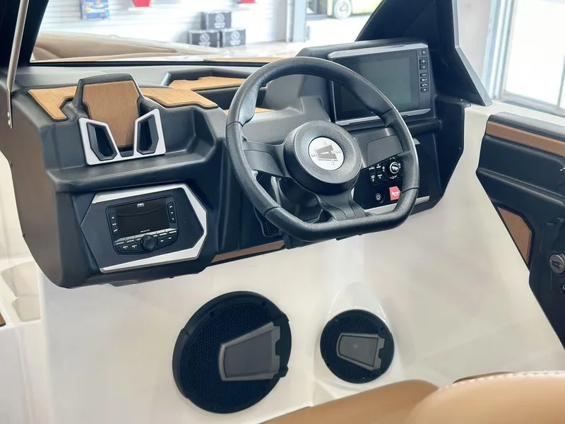 Slide: The Image of 2025 Axis A245 boat dashboard with steering wheel, control panel, and speakers. - 10