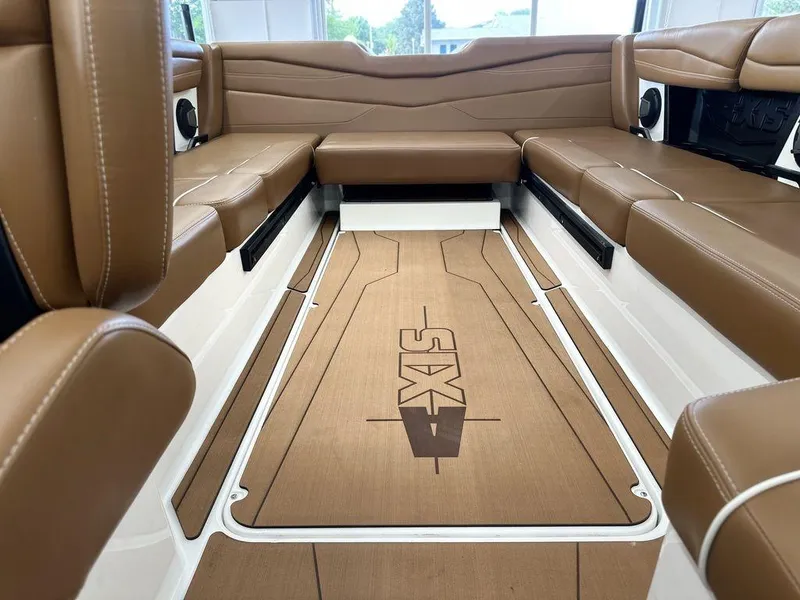 Slide: The Image of 2025 Axis A245 boat interior with brown leather seating and custom flooring. - 11