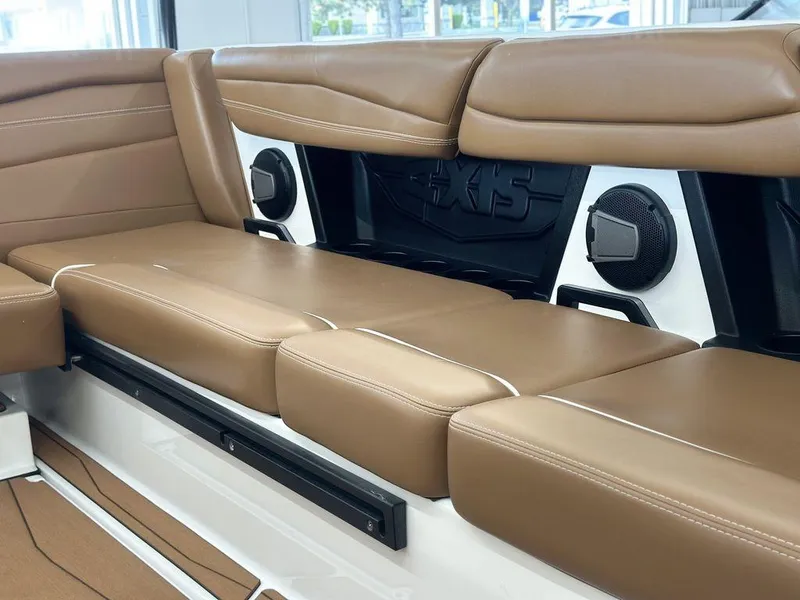 Slide: The Image of 2025 Axis A245 boat interior with tan leather seating and built-in speakers. - 9