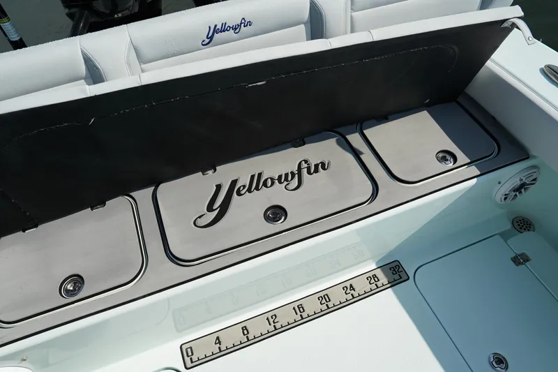Slide: The Image of 2020 Yellowfin 26 Hybrid boat interior with storage compartments and measuring scale. - 10