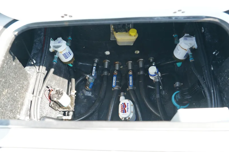 Slide: The Image of Bilge area of 2020 Yellowfin 26 Hybrid boat showing pumps and hoses. - 12