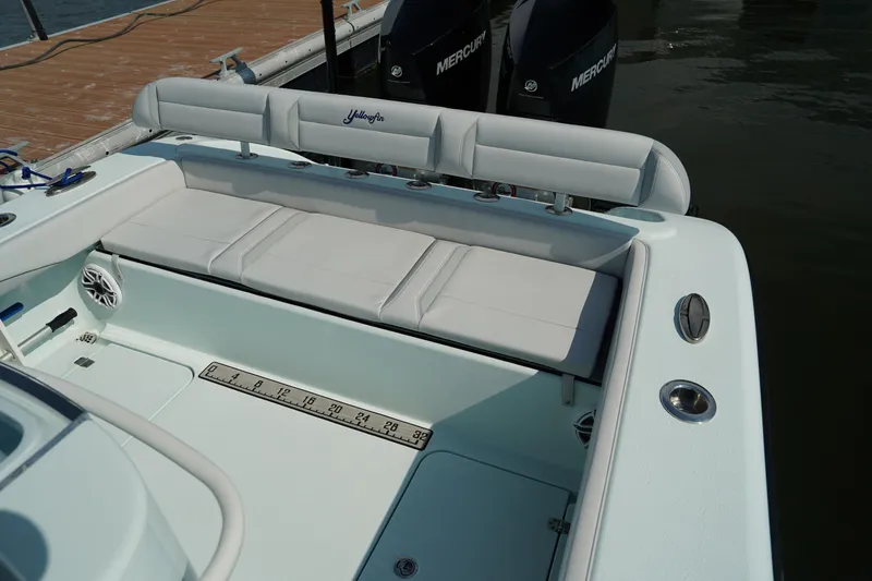 Slide: The Image of 2020 Yellowfin 26 Hybrid boat with cushioned seating and dual Mercury engines. - 15