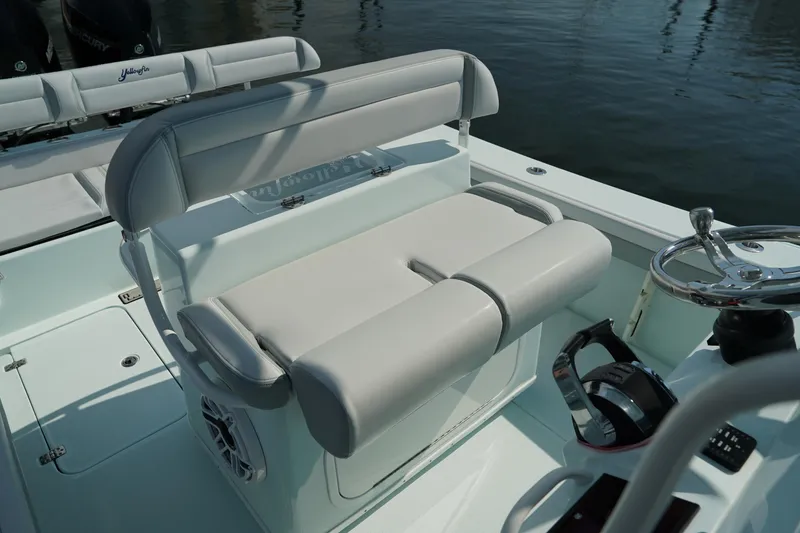 Slide: The Image of 2020 Yellowfin 26 Hybrid boat interior with cushioned seating and steering wheel. - 17