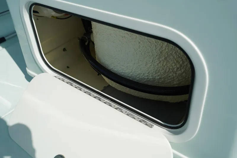 Slide: The Image of Open storage compartment on a 2020 Yellowfin 26 Hybrid boat. - 18