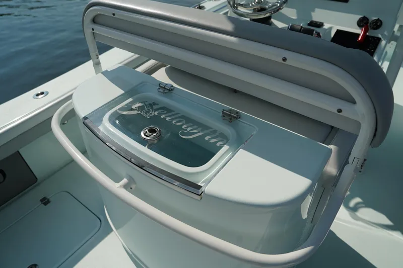Slide: The Image of 2020 Yellowfin 26 Hybrid boat interior with storage compartment and steering wheel. - 20