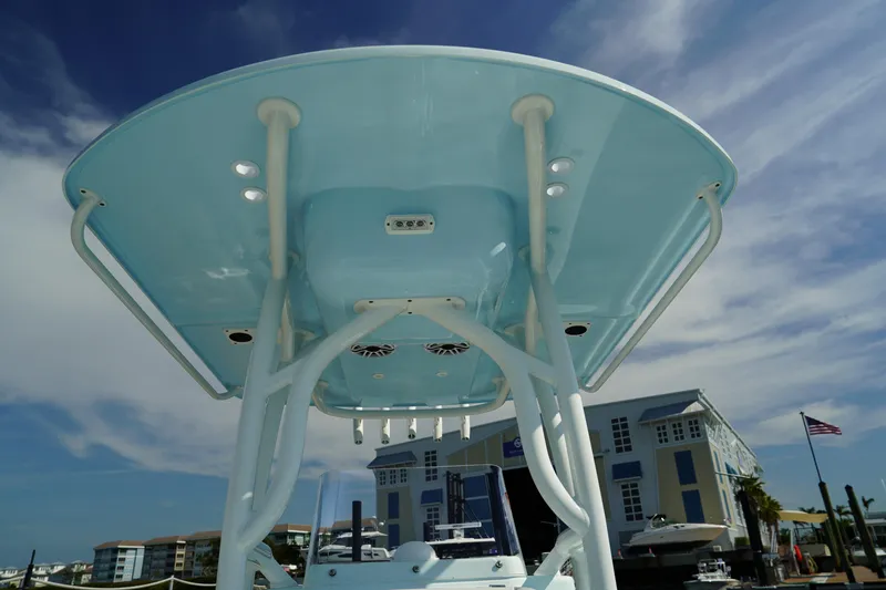 Slide: The Image of 2020 Yellowfin 26 Hybrid boat with T-top, docked at marina under blue sky. - 23