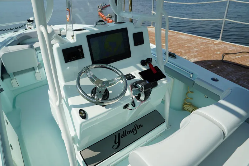 Slide: The Image of 2020 Yellowfin 26 Hybrid boat console with steering wheel and navigation screen. - 24