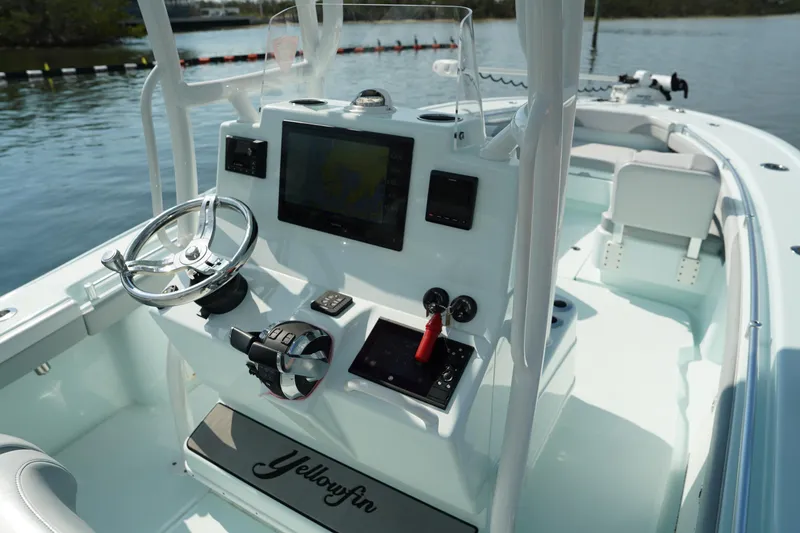 Slide: The Image of 2020 Yellowfin 26 Hybrid boat console with steering wheel and navigation system. - 25
