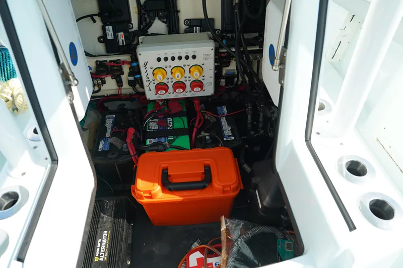 Slide: The Image of 2020 Yellowfin 26 Hybrid boat interior with electrical components and orange storage box. - 28