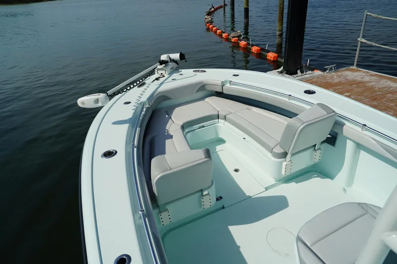 Slide: The Image of 2020 Yellowfin 26 Hybrid boat with spacious seating, docked by the water. - 34