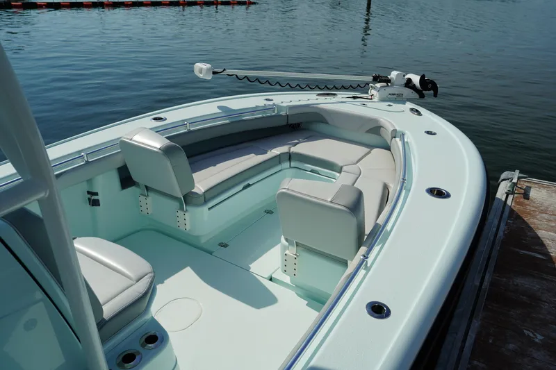 Slide: The Image of 2020 Yellowfin 26 Hybrid boat with seating, docked on calm water. - 35