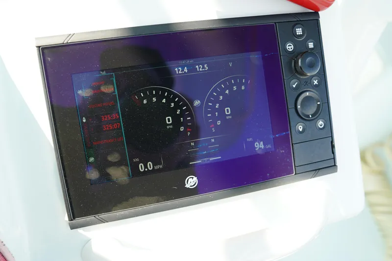 Slide: The Image of Dashboard display of a 2020 Yellowfin 26 Hybrid boat showing gauges and controls. - 38